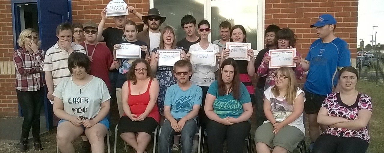 SAY | Group of people with signs | Adults with Learning Disability | Choices Advocacy